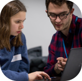 Selfie-days yoti team member teaching child how to code