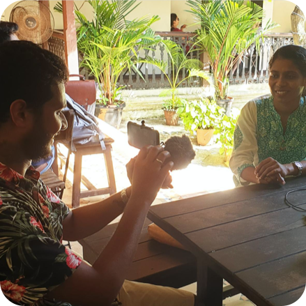 fellowship-programme man talking and interviewing woman with a mobile phone outside