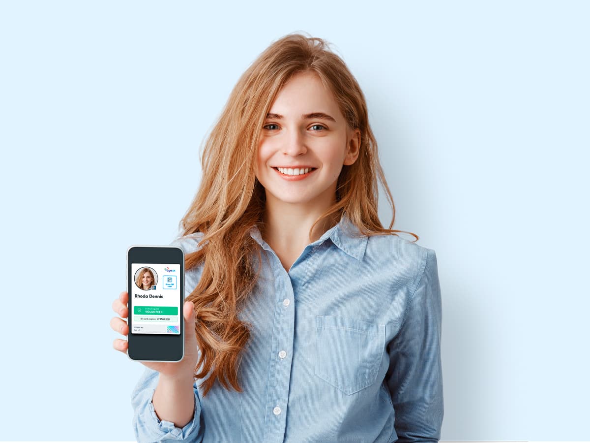 Girl showing smartphone with Age UK digital ID card