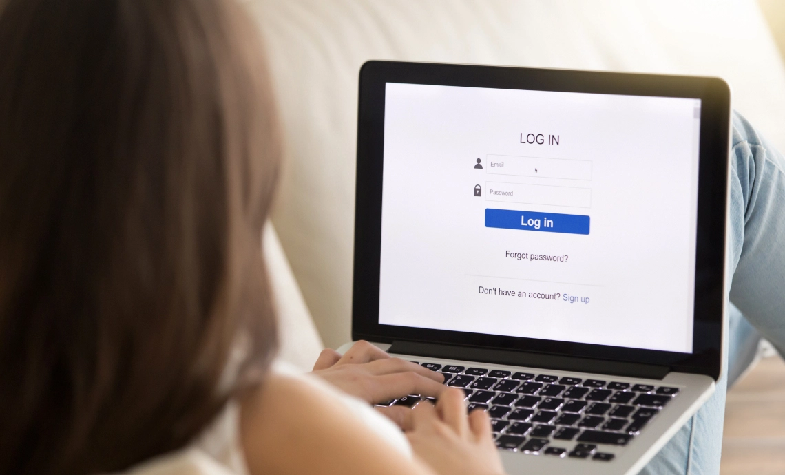 A lady using a log-in page on a laptop