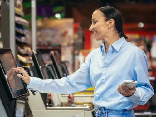 Woman using self checkout machine