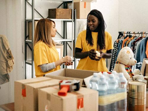 Two women organising donations at a Charity