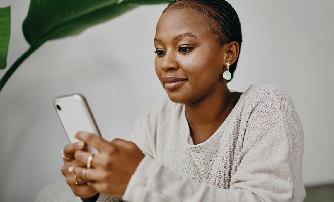 image of a woman looking at her phone