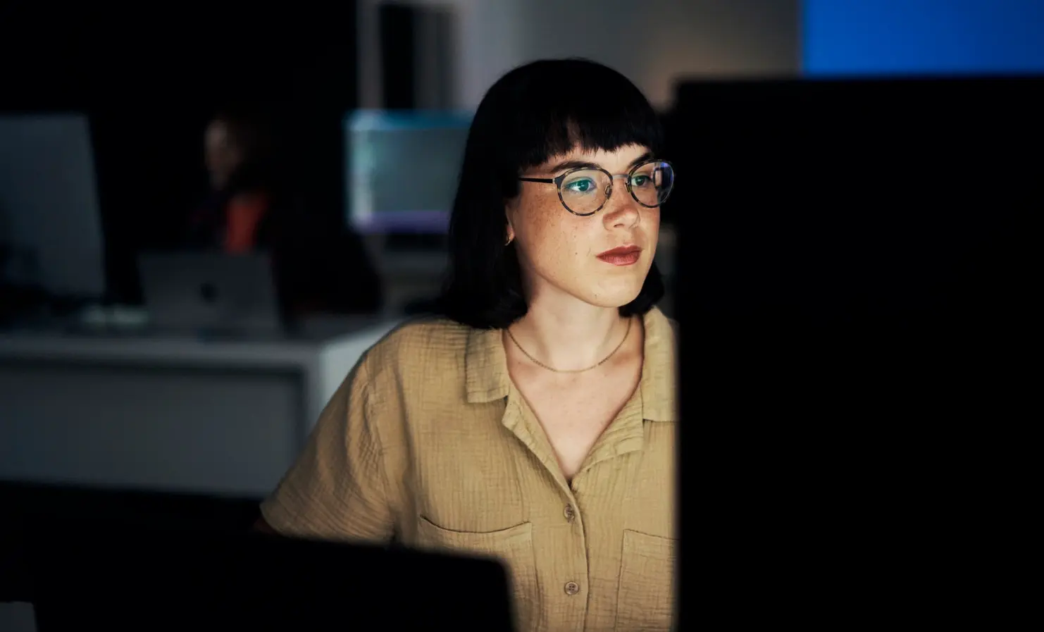 An image of a woman looking at a computer screen.