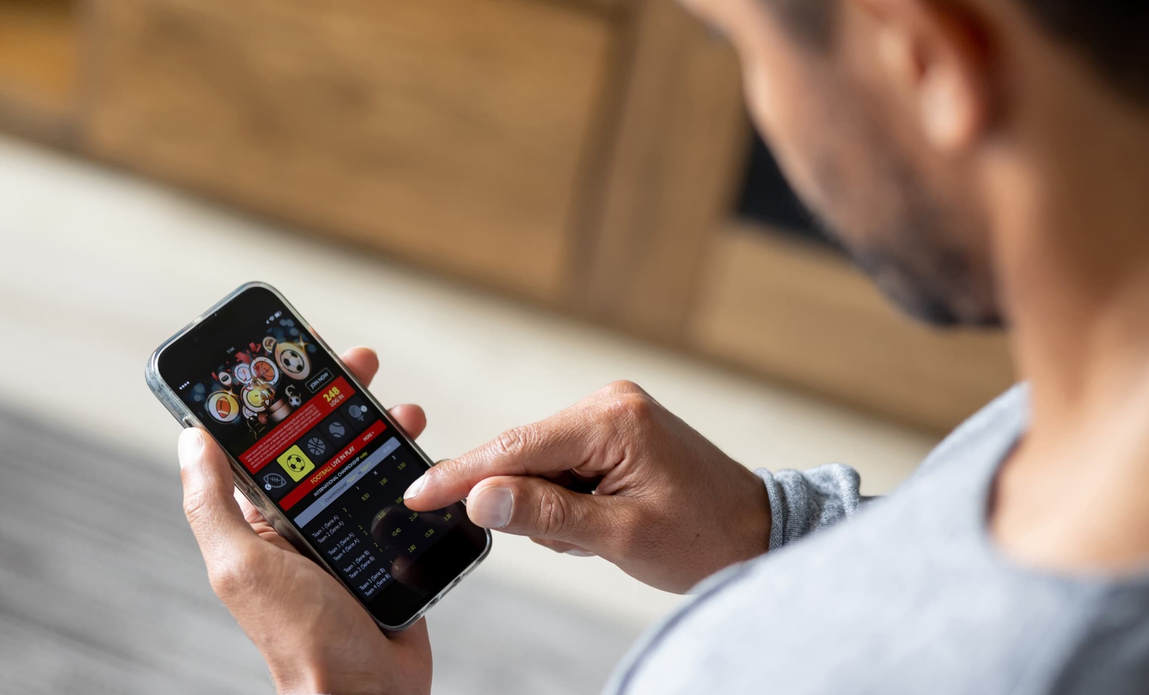 Person using betting app on smartphone