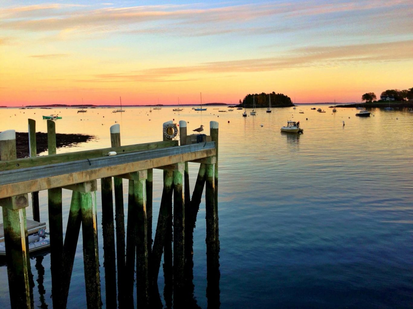 a scenic image of the sun setting over a large body of water