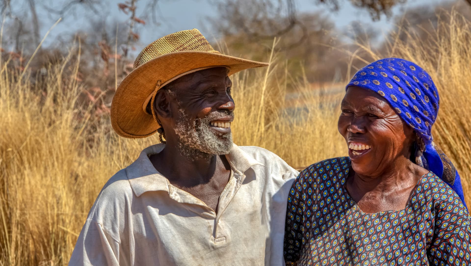 an image of two joyful people, looking at each other and laughing together