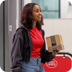 Cinemas_mail_collection Girl holding a parcel in the Post Office