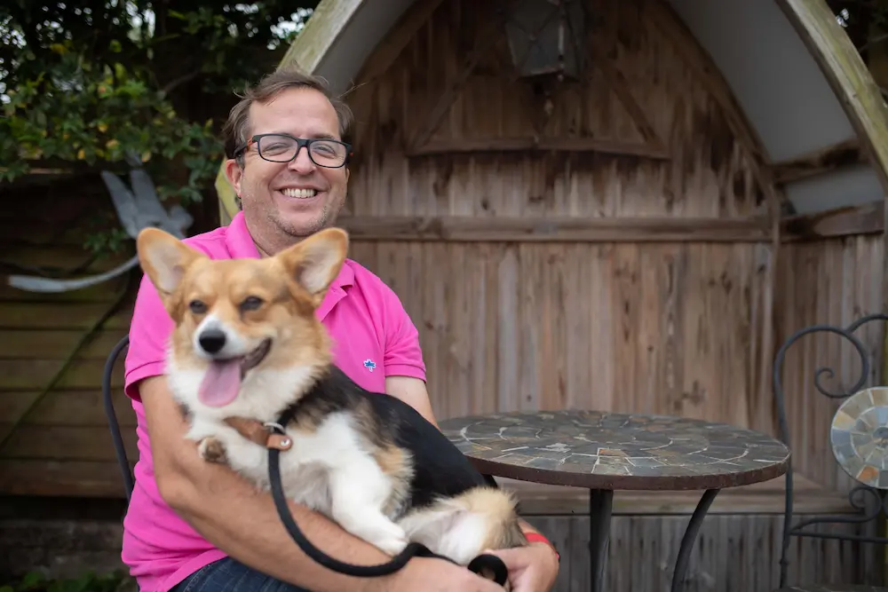 Corgi breeder Johnathan with a puppy on his lap