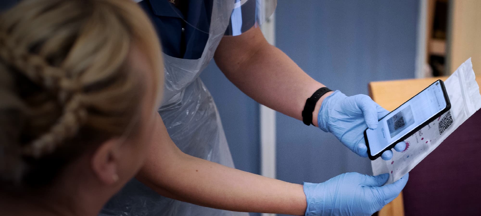 Nurses scanning QR codes as part of covid-19 testing system