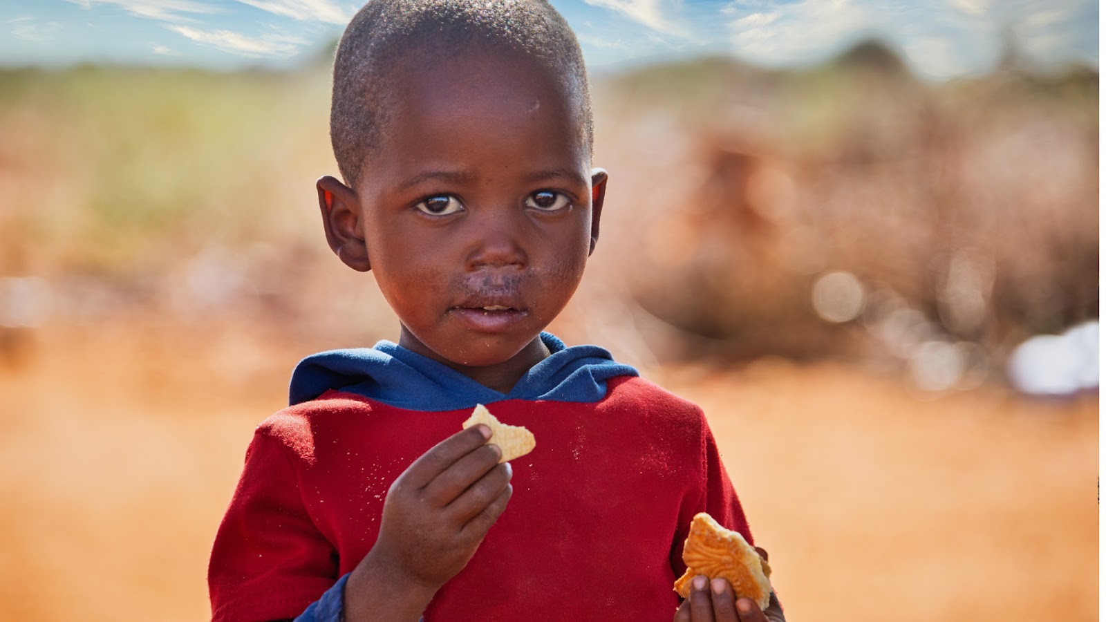 image of a young boy eating some food