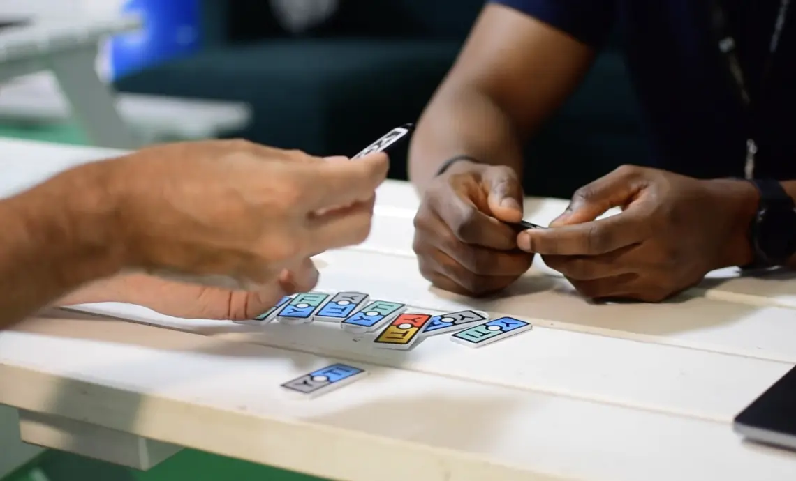 An image of two people sorting through Yoti-branded stickers