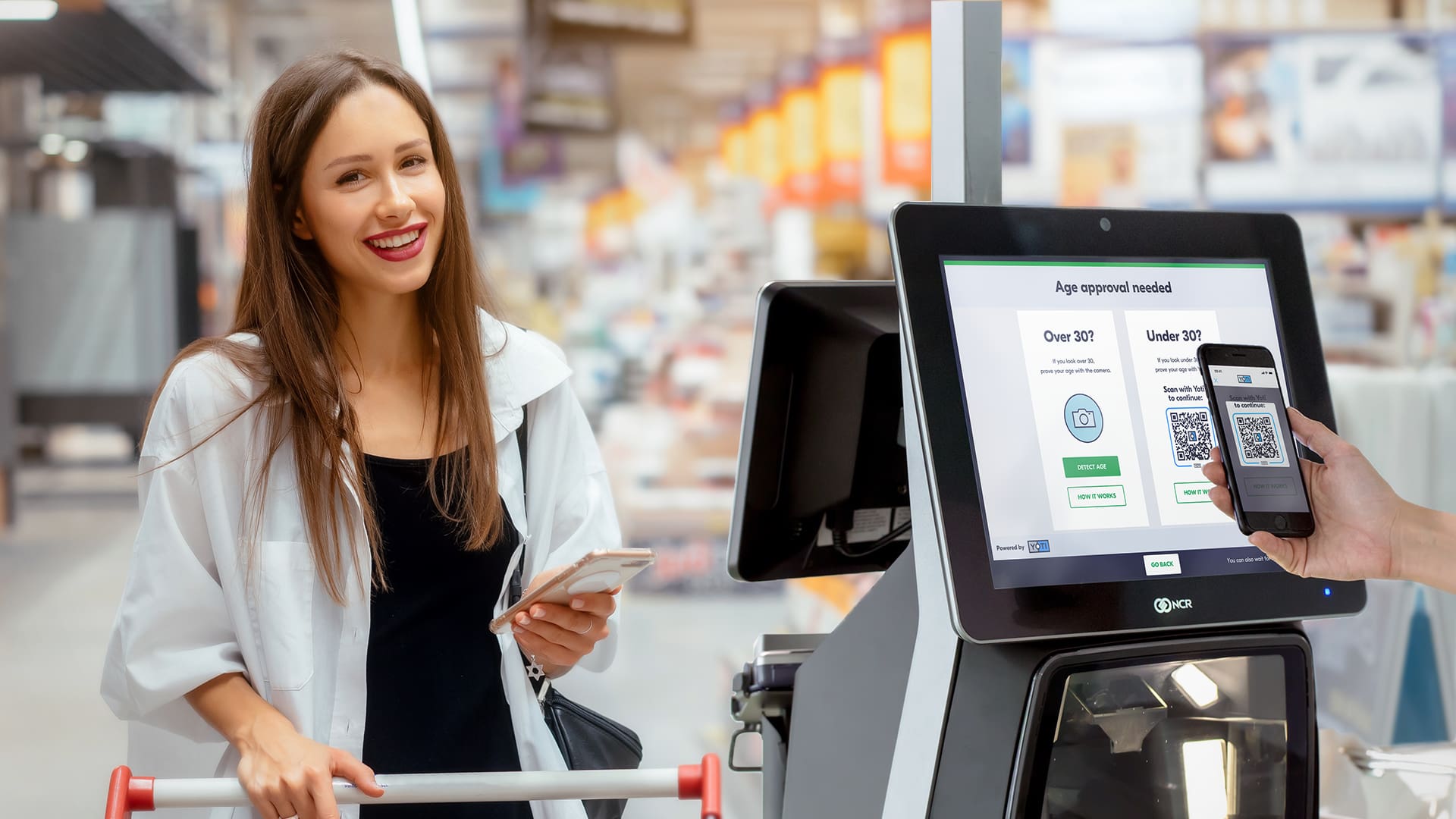 Woman using Yoti's age estimation solution at the self checkout in a supermarket