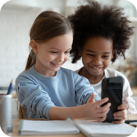children-using-facial-age-estimation Two children using Yoti's facial age estimation on a mobile device.