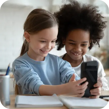 Two young children using a smartphone