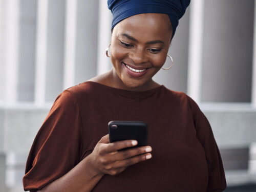 Woman looking at smartphone smiling