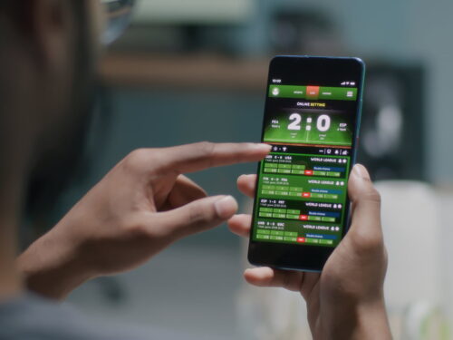 person "sports betting" on smartphone