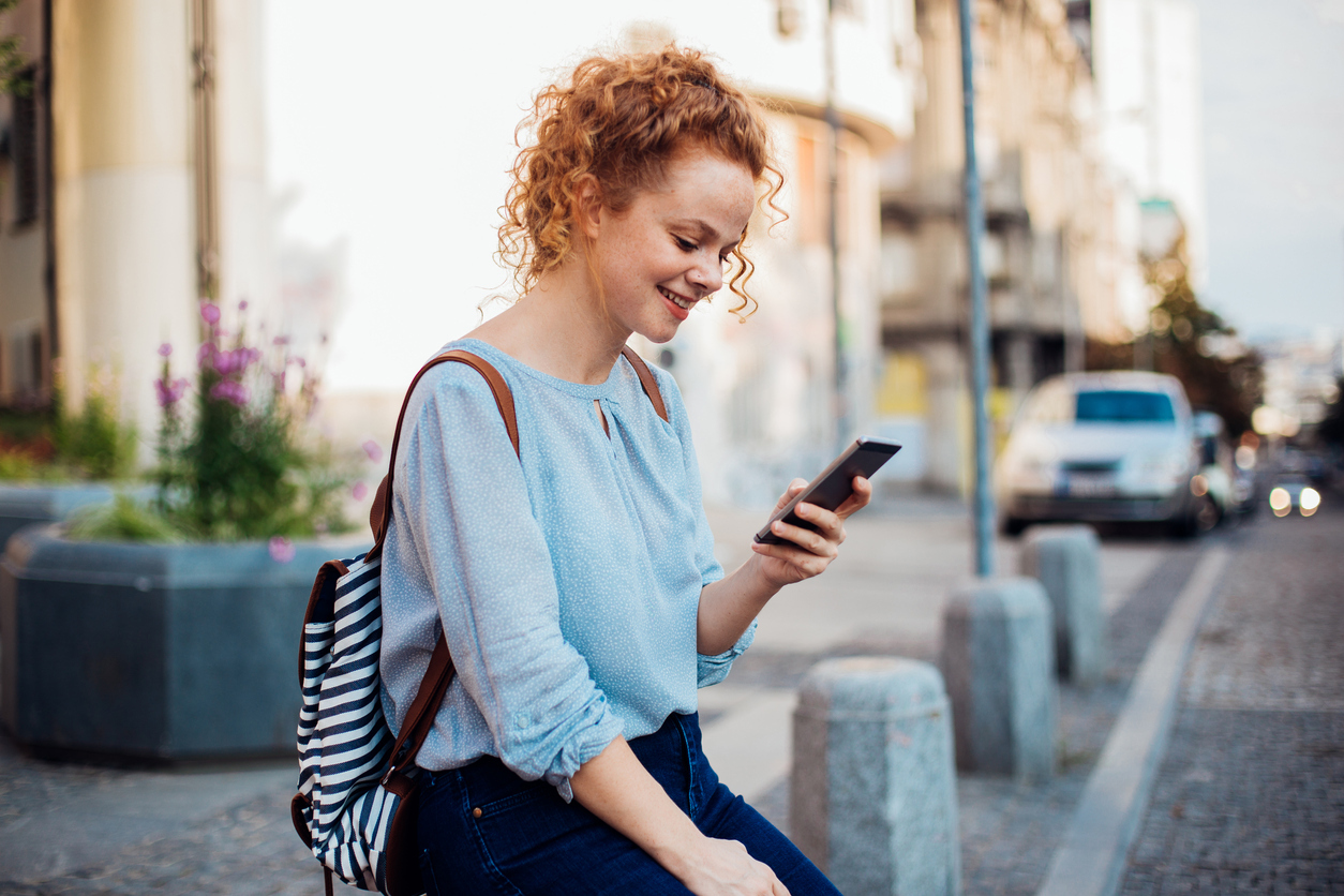 Young woman using digital ID on her phone