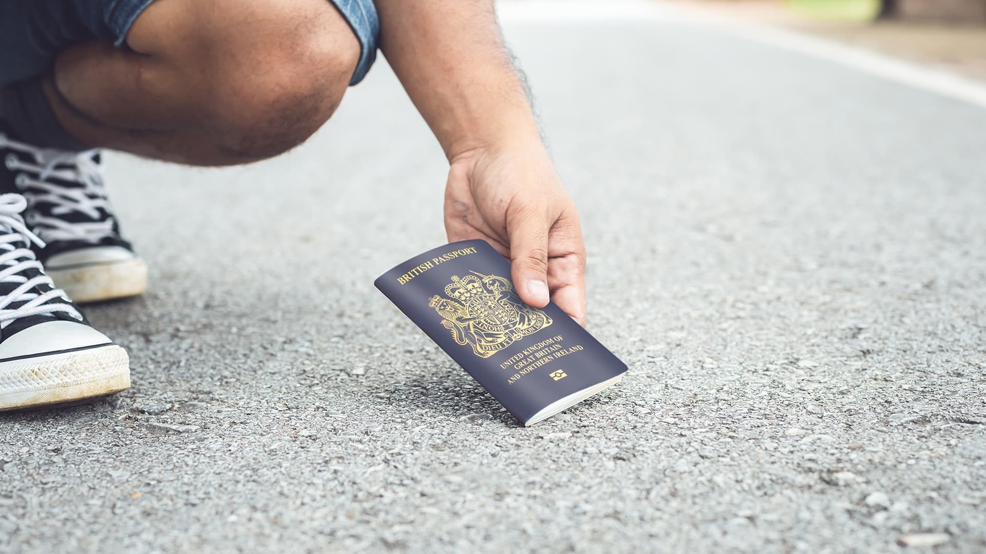 Man picking up passport from the floor